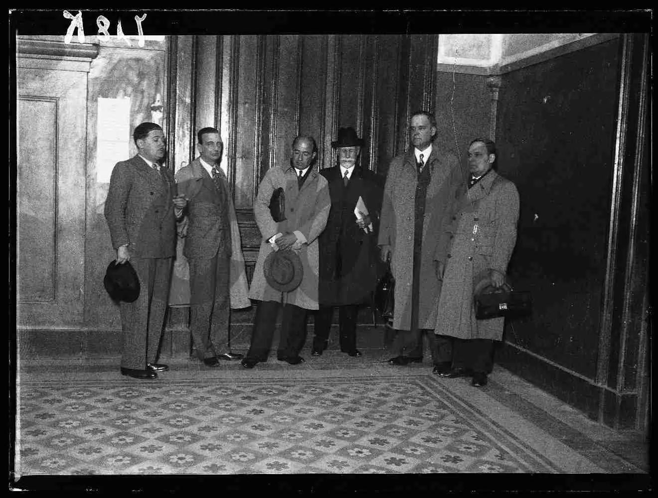 Frederico Bívar Velho da Costa, third from the left, with a group of men in a formal hallway